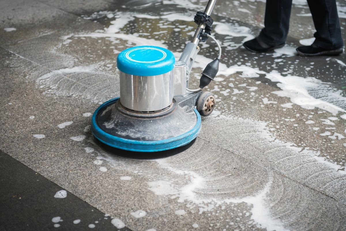 A person using a machine to clean a floor, emphasizing the effectiveness of water in carpet cleaning.